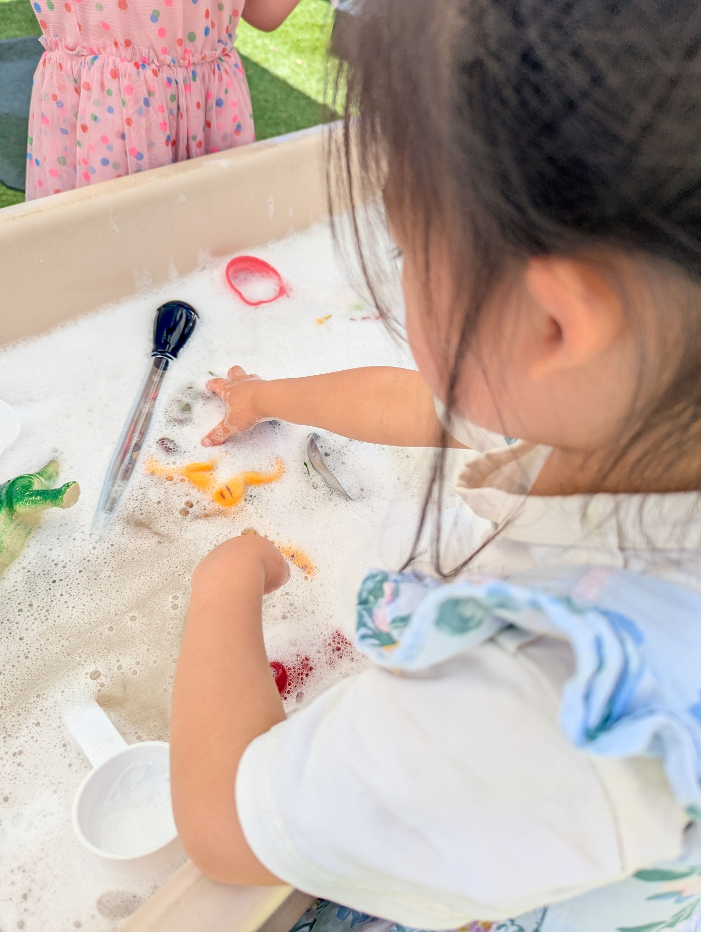 Child exploring at the water table